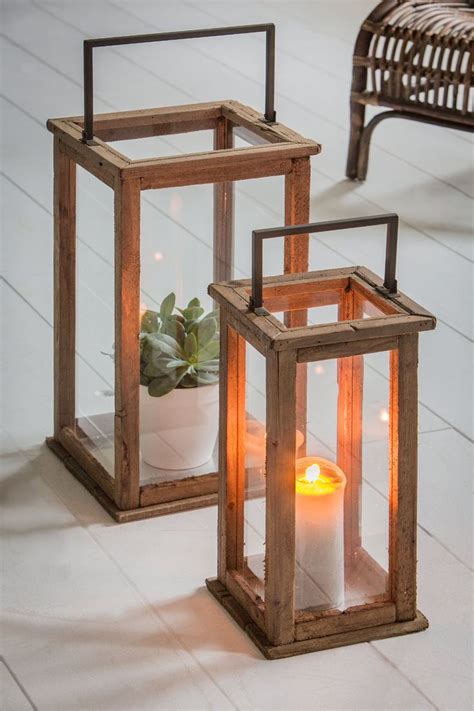 Two Wooden Lanterns Sitting On Top Of A White Floor