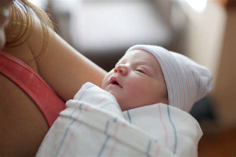 A Mother Holds Her Newborn Infants Hand After Breech Delivery Madison