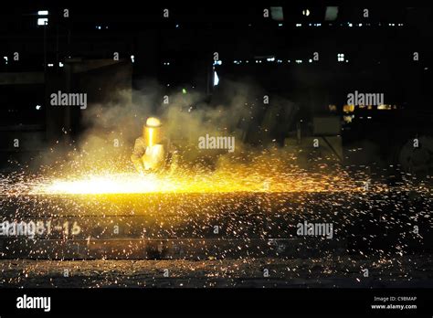 worker using torch cutter to cut through metal Stock Photo - Alamy