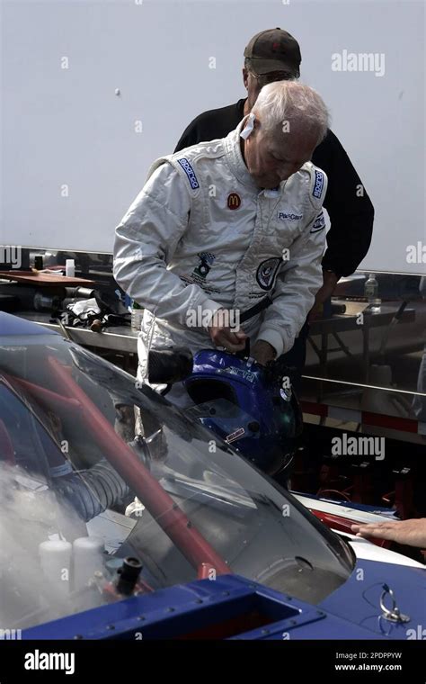 Actor And Race Car Driver Paul Newman Adjusts His Racing Helmet Before