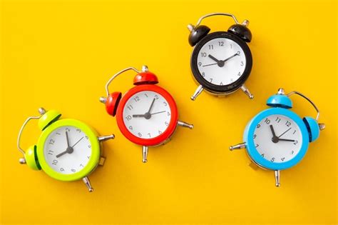 Premium Photo Alarm Clock On Yellow Background