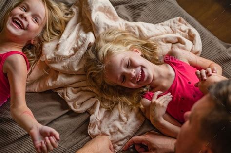 Daddy Has Fun Playing With His Two Daughters In Bikini Suits Painted With Markers At Home