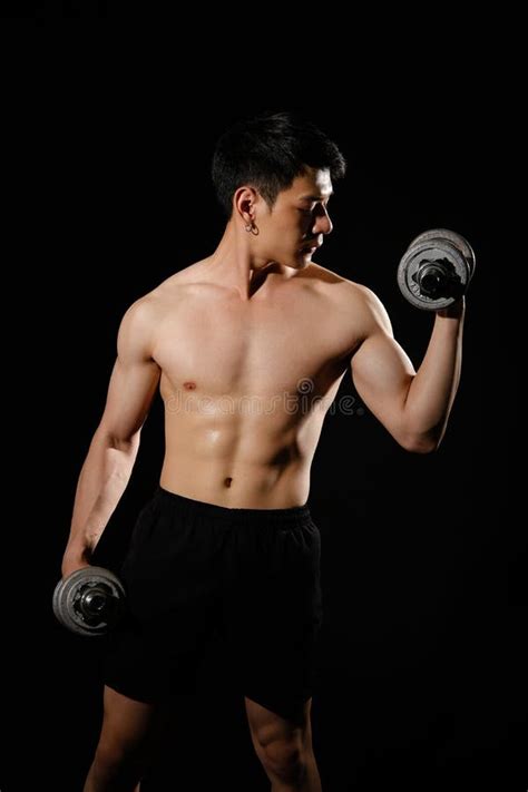 Athletic Muscular Bodybuilder Man With Naked Torso Six Pack Abs Working Out With Dumbbell