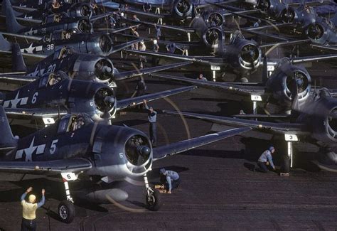 The Flight Deck Crew Prepares Grumman F6f Hellcat Fighters Of Vf 16 And