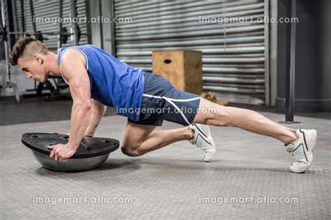 Muscular Man Doing Push Up On Bosu Ball