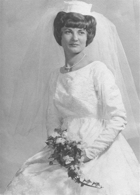 A close-up portrait pose of my dress, pill box veil and wedding bouquet