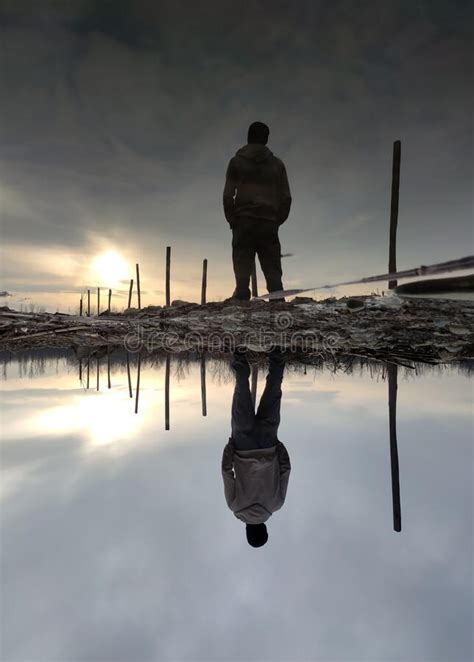 Reflection Of A Man In Water During Sunset Stock Photo Image Of