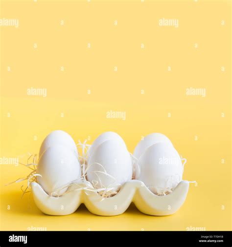 Organic White Chicken Eggs In Porcelain Decorative Box On Yellow