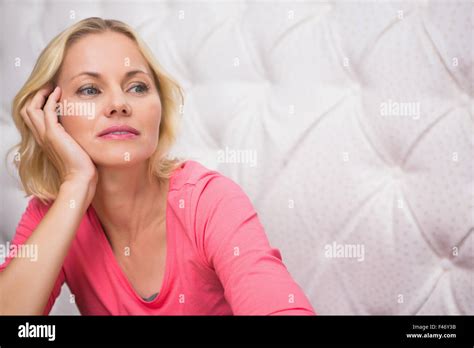 Pretty Blonde Sitting And Thinking Stock Photo Alamy
