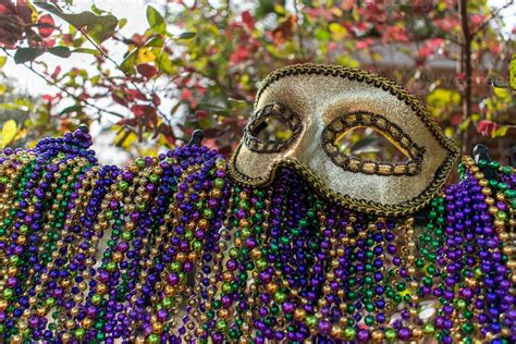 Mardi Gras Beads Covering Wrought Iron Fence With Carnival Mask 8724634