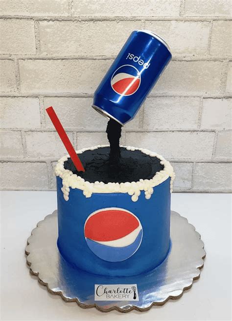 A Cake With A Pepsi Can On Top And A Toothbrush Sticking Out Of It