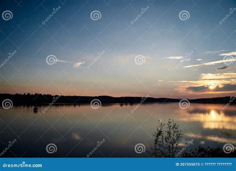 Beautiful Lake View During Sunset With Blue And Yellow Sky Reflection