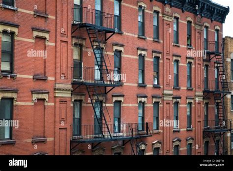 Red Brick Apartment Building With Fire Escape In New York City Stock