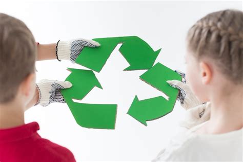 Free Photo | Back view children holding recycle sign