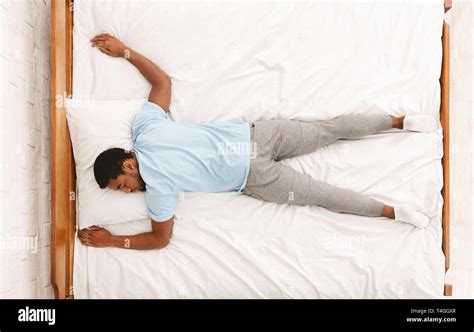 Young African American Man Sleeping In Bed Top View Stock Photo Alamy