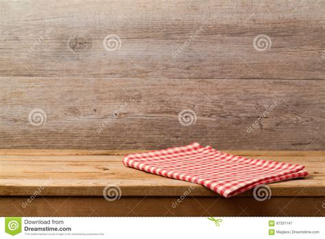 Empty Wooden Deck Table With Checked Red Tablecloth Over Wooden Wall