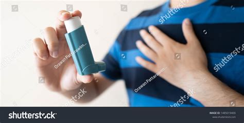 Young Man Using Blue Asthma Inhaler Stock Photo 1485019400 | Shutterstock