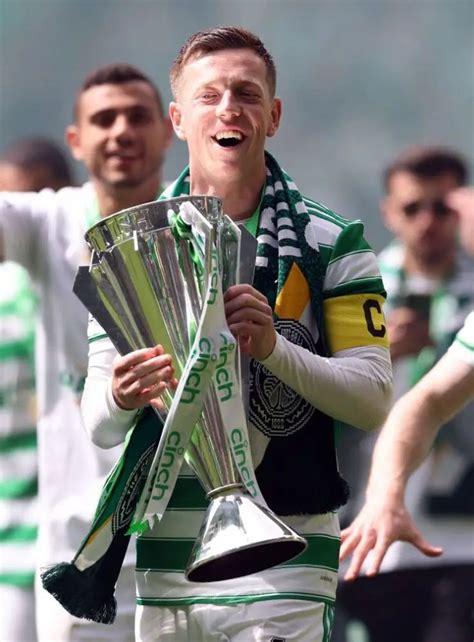 A Soccer Player Is Holding Some Silver Cups