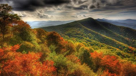 Mountain Of Fall Foliage And A Dark Blue Sky With Clouds Background ...