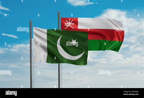 Oman And Pakistan Flag Waving Together In The Wind On Blue Sky Two