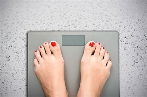 280 Person Stepping On Scale Stock Photos Pictures And Royalty Free