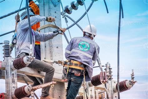 Electricians are climbing on electric poles to install and repair power