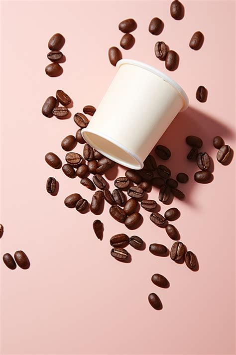 Coffee Beans Spill Out Of Their Paper Cups Background Wallpaper Image