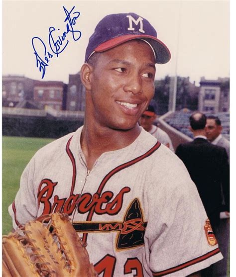 A Baseball Player Holding A Catchers Mitt And Smiling