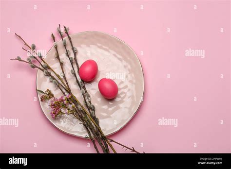 Plate With Beautiful Flowers Pussy Willow Branches And Painted Easter Eggs On Pink Background