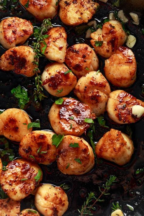 Scallops Seared In Garlic And Parsley Butter Served On Crumpled Paper