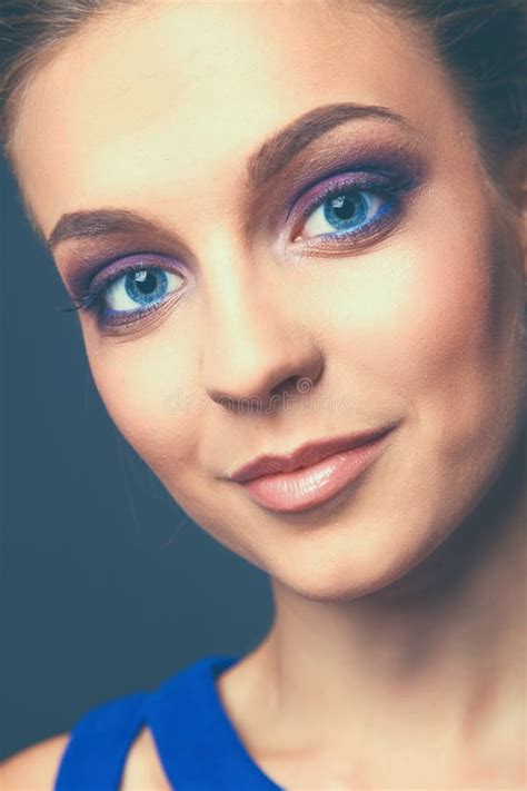 Studio Shot Of A Beautiful Young Woman Wearing Professional Makeup