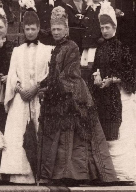 An Old Black And White Photo Of People Dressed In Period Clothing