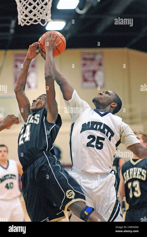 Basketball Players battle as they try to secure a offensive rebound during high school action ...