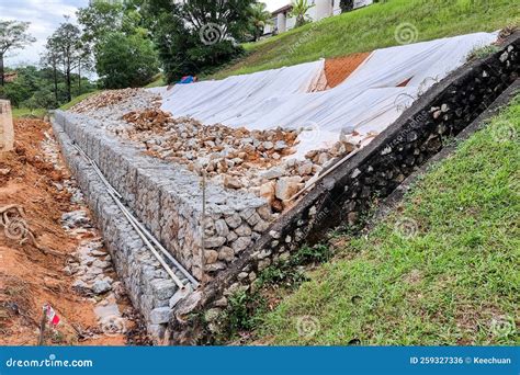 Series Of Slope Retention Construction Design With Rocks And Mesh To