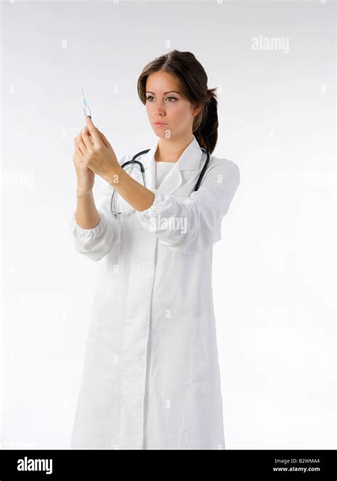 Cute Brunette In White Medical Gown And A Syringe Stock Photo Alamy