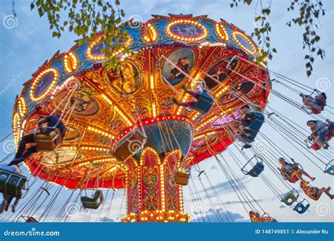 People Ride The Chain Carousel In An Amusement Park Cheboksary Russia