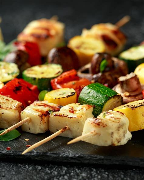 Grilled Halloumi Cheese Skewers With Vegetables On Rustic Stone Board