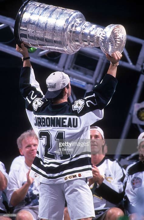 Guy Carbonneau of the Dallas Stars holds aloft the Stanley Cup Trophy ...