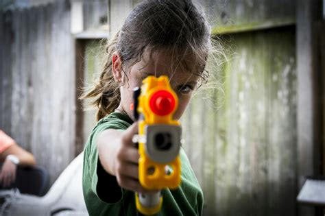 Premium Photo | Cute girl playing with squirt gun outdoors