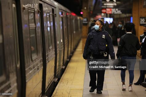 An Nypd Officer Patrols The Subway Platform At The 36 Street Subway