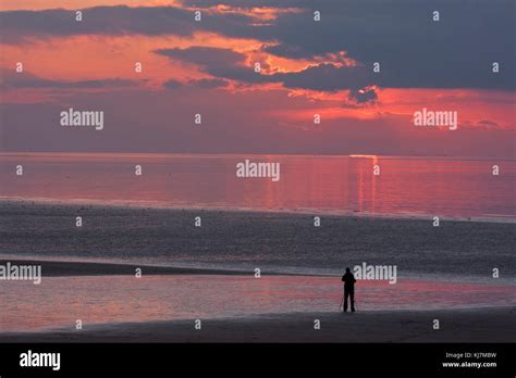 Single Photographer Photographing Sunset Over The Wash Hunstanton