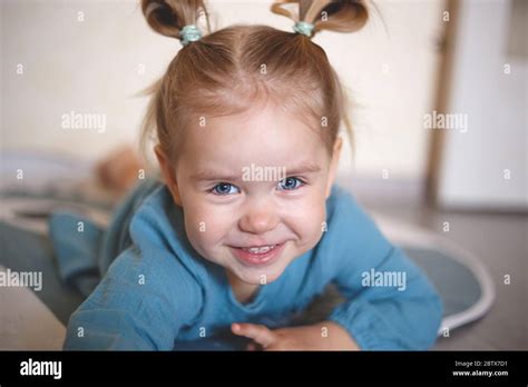 Blue Eyed Blonde Girl In A Vintage Blue Dress Smiling Stock Photo Alamy