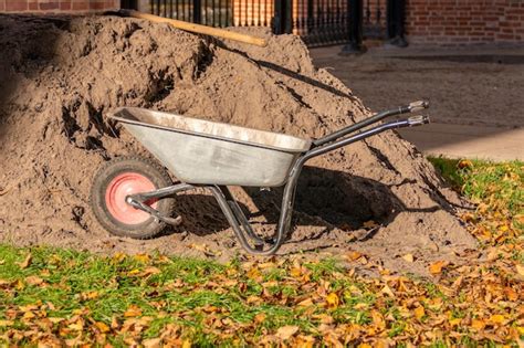 Premium Photo A Wheelbarrow Is Sitting In Front Of A Pile Of Dirt