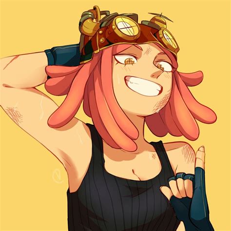 A Woman With Pink Hair And Goggles On Her Head Is Posing For The Camera