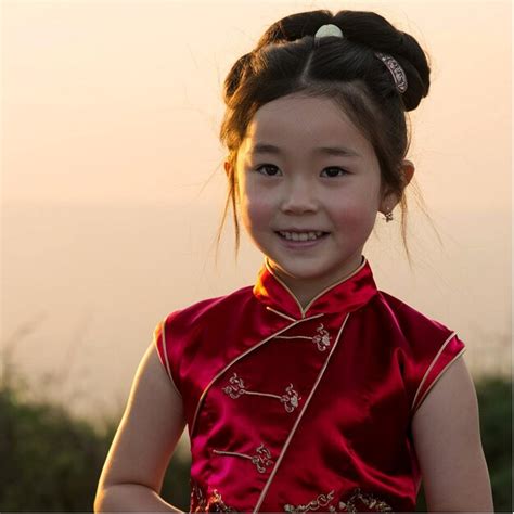 A Girl Wearing A Red Dress With A Red Bow On The Front Premium Ai Generated Image