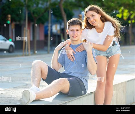 Girl Is Hugging Guy From Behind Stock Photo Alamy