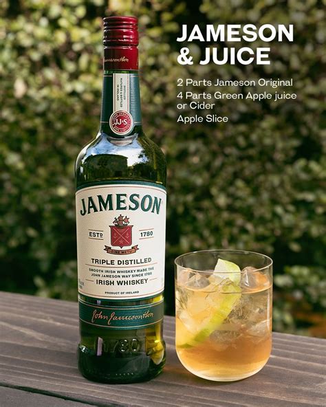 a bottle of jameson on a table next to a glass with an alcoholic drink ...