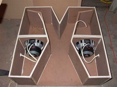 Two Speakers Are In The Middle Of A Cardboard Box With Wires Coming Out