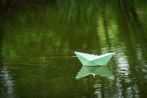 Origami Paper Boat Floats On The River Children`s Summer Entertainment