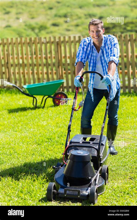 Cheerful Man Lawn Mowing In His Home Garden Stock Photo Alamy